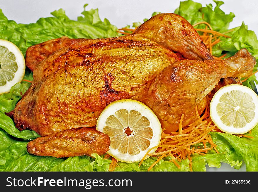 Chicken roasted with lemon and lettuce. Chicken roasted with lemon and lettuce