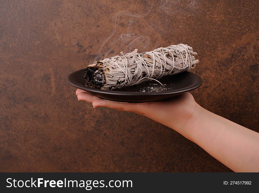 Burning  bundle of White Sage. Cleanse the house with aroma smoke. Horizontal with space for text