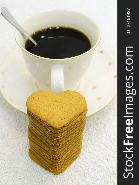 Big cup of black coffee and pile of gingerbreads. Big cup of black coffee and pile of gingerbreads