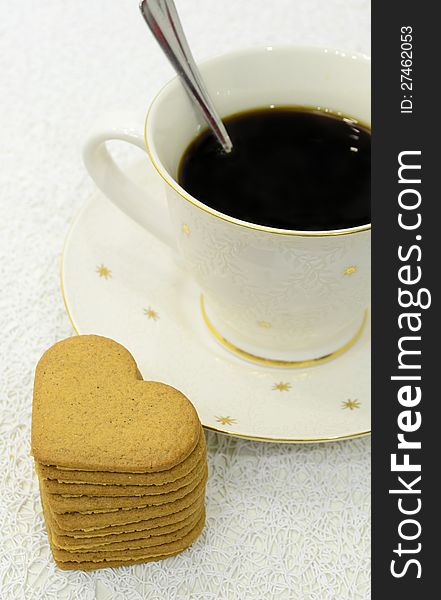 Big cup of black coffee and pile of gingerbreads. Big cup of black coffee and pile of gingerbreads