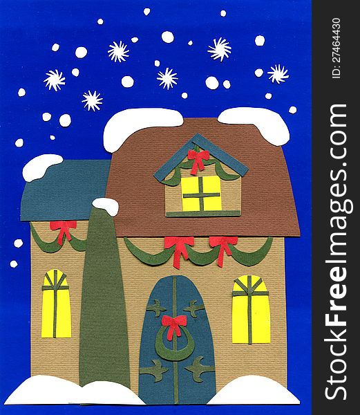 The paper cutout of the decorated house in snowfall. The paper cutout of the decorated house in snowfall