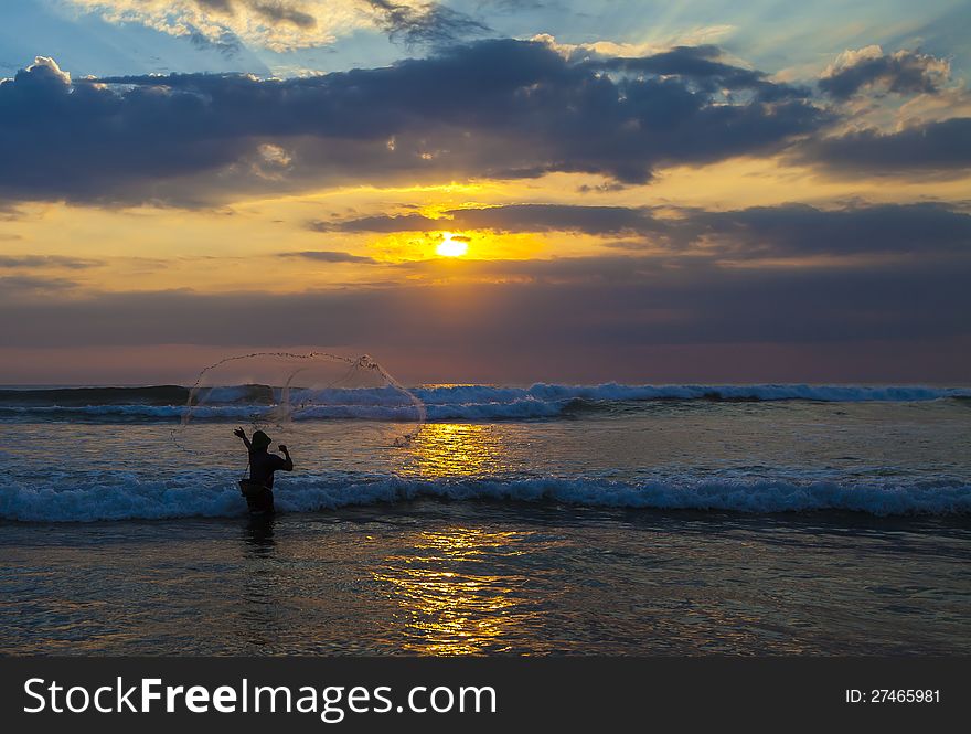 Fisherman With Net At Sunset