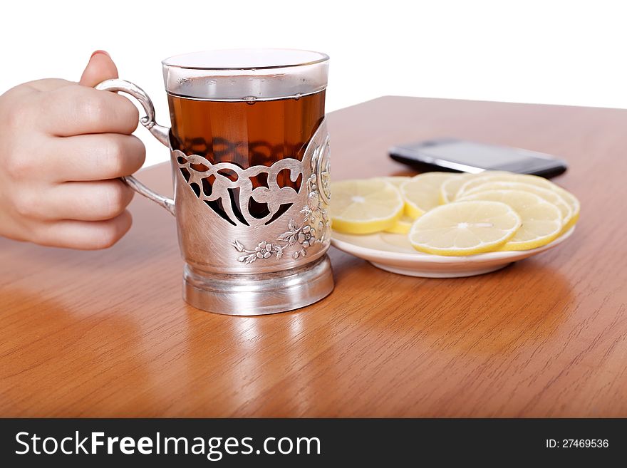 Hot aromatic tea with lemons on the table