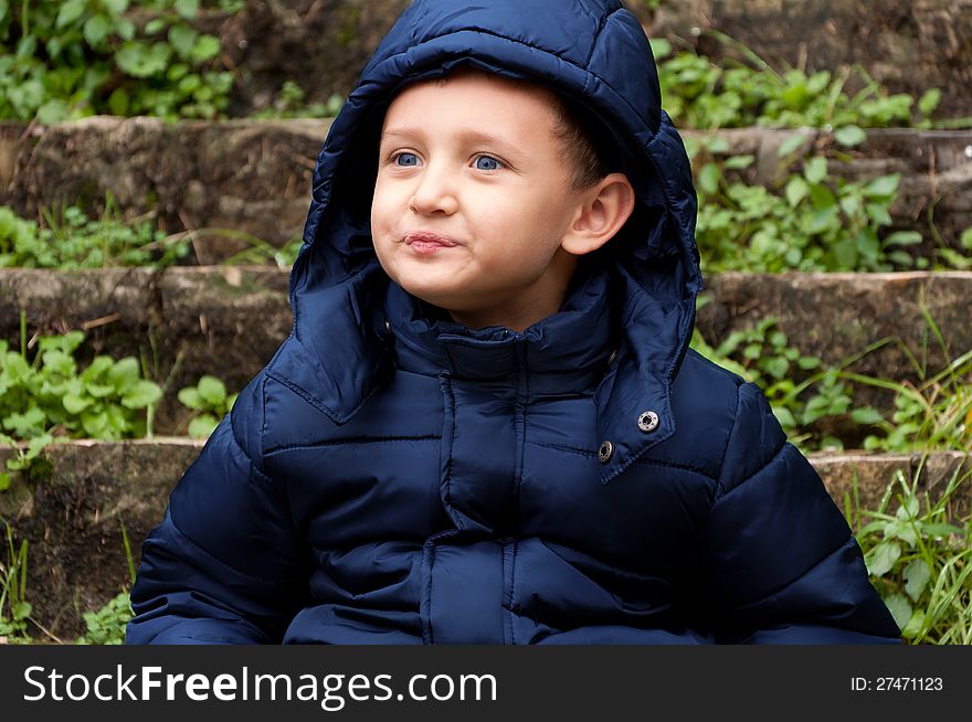 Little boy with thoughtful look outdoors. Little boy with thoughtful look outdoors