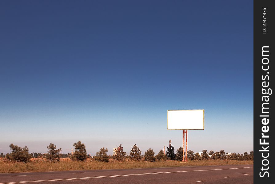 Road in a village with an empty billboard. Road in a village with an empty billboard