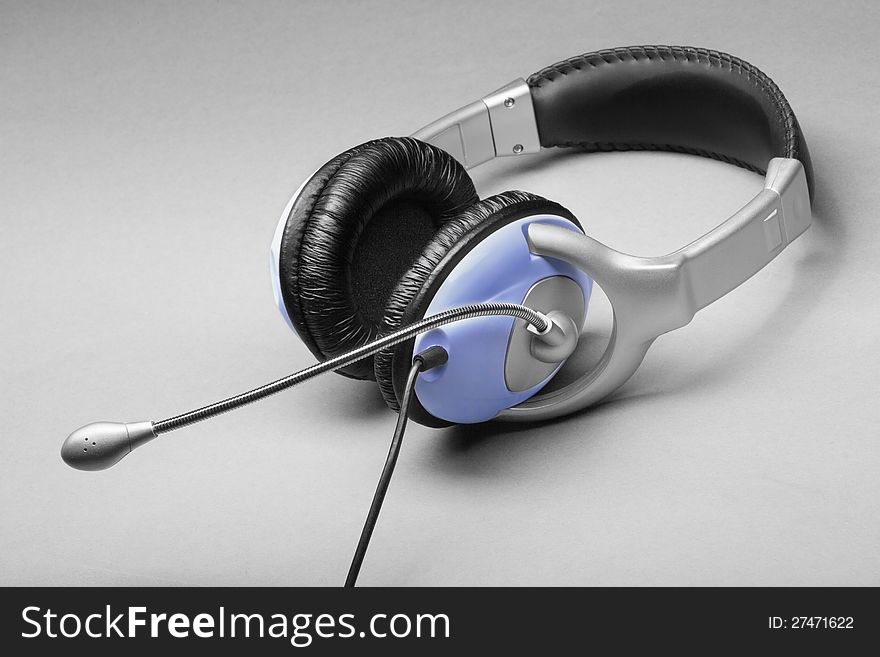 Headphones with a microphone on a gray
