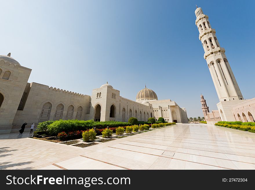 Wide angle shot of outside areas at the Sultan Qaboos Grand Mosque in Muscat, Oman. The main minaret is visible to the right, and the main dome in the middle. Wide angle shot of outside areas at the Sultan Qaboos Grand Mosque in Muscat, Oman. The main minaret is visible to the right, and the main dome in the middle.