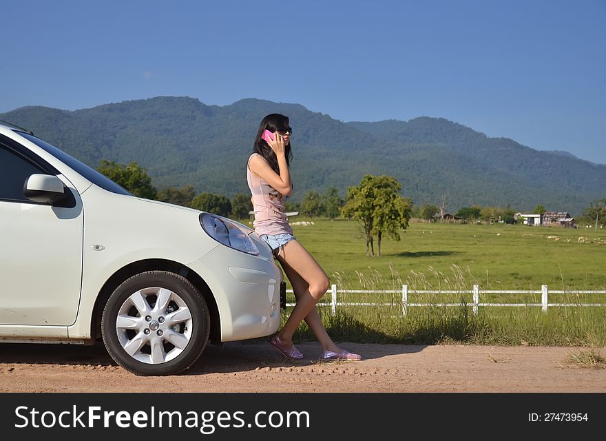 Pretty women use her phone in the country