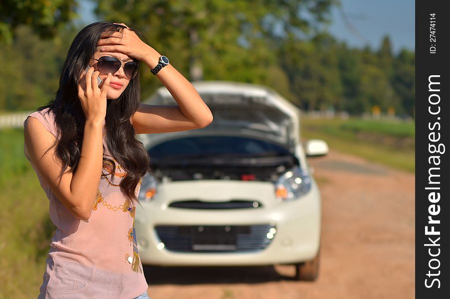 A woman calls for assistance after her car broke down