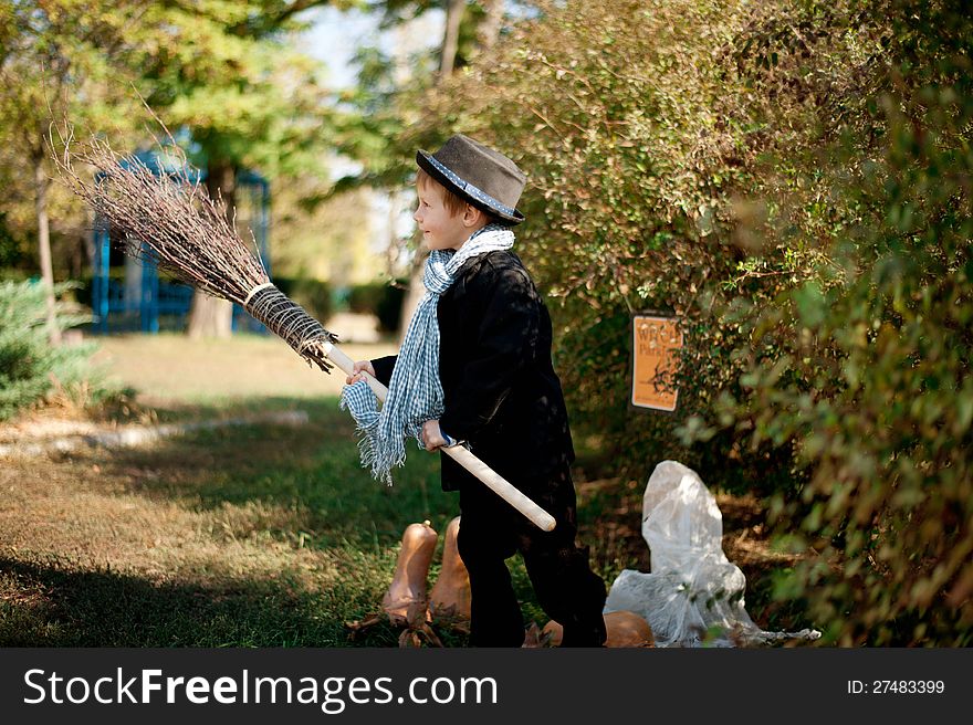 The nature boy in black hat and coat celebrates Halloween