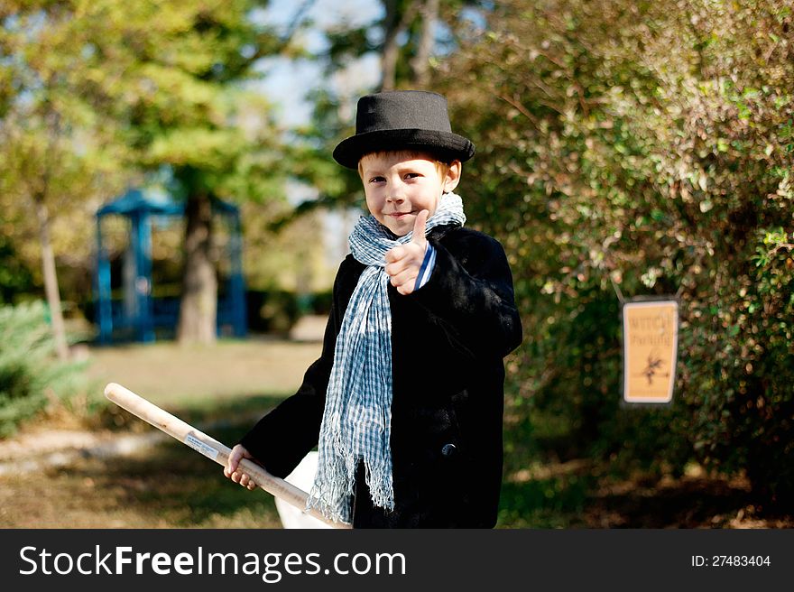 The nature boy in black hat and coat celebrates Halloween