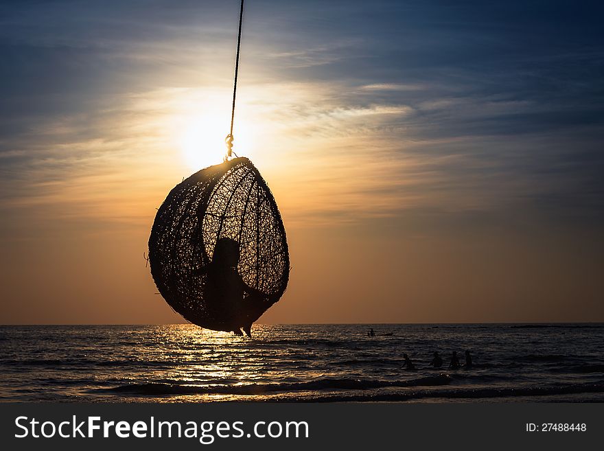 Little Girl Sitting On The Rattan Swing