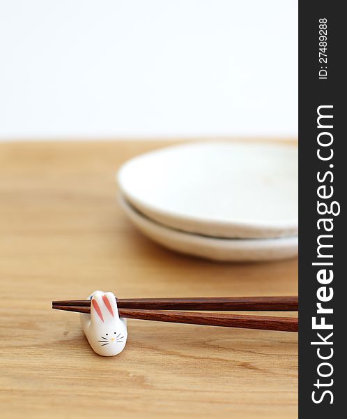 Chopsticks with asian set table on white background
