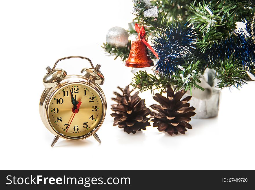 Clock,bumps on the background of a decorated Christmas tree in the white. Clock,bumps on the background of a decorated Christmas tree in the white