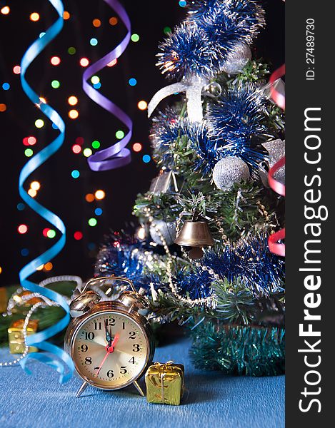 Clock,ball,the serpentine,a new year tree on a black background with lights. Clock,ball,the serpentine,a new year tree on a black background with lights