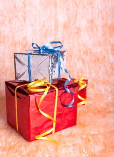 Three Gift Boxes On An Orange Stock Photos