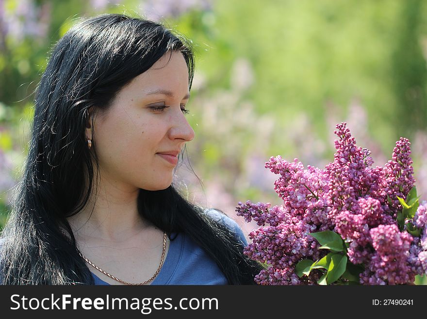 Young woman with syringa bouquet