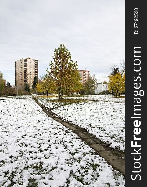 Prefabricated housing estates with snow and trees with yellow leaves. Prefabricated housing estates with snow and trees with yellow leaves