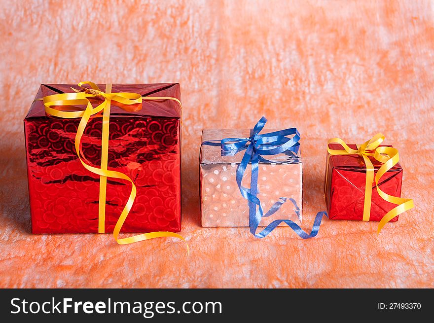 Three gift boxes on an orange background