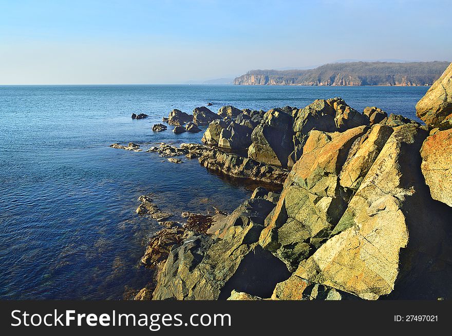 The line of rocks going away in the depth of the sea. The line of rocks going away in the depth of the sea