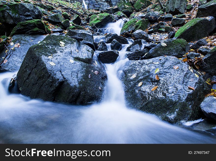 Forest stream in mountains running over mossy rocks. Forest stream in mountains running over mossy rocks