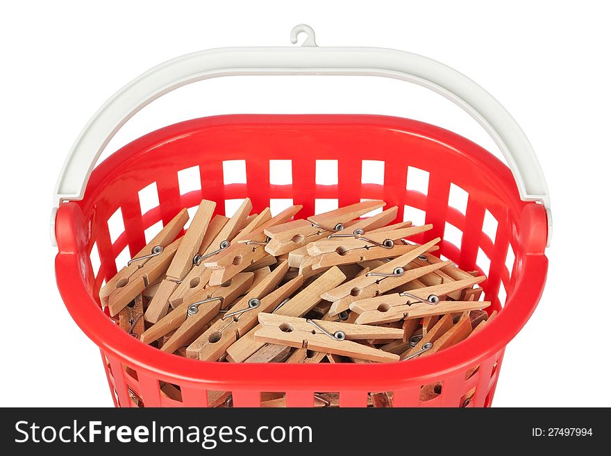 Set of clothespins in the red basket. Closeup.