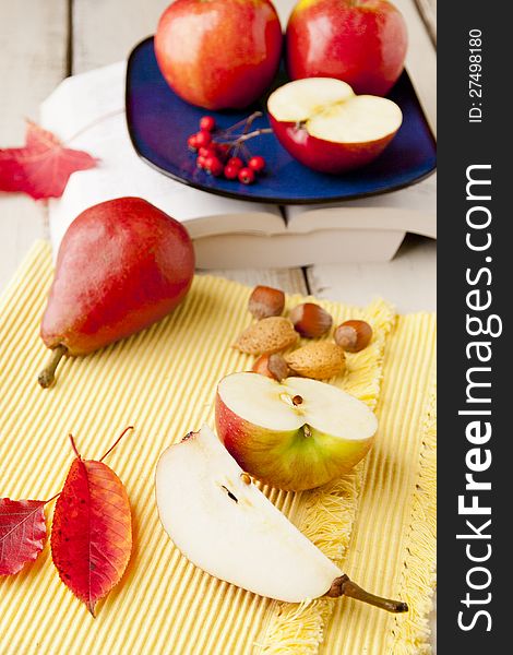 Apples and pears on wood table. shallow dof