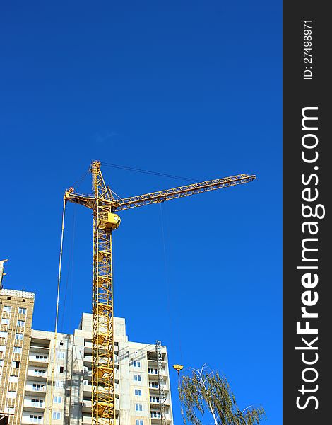 Construction of multistory building with a construction crane. Construction of multistory building with a construction crane