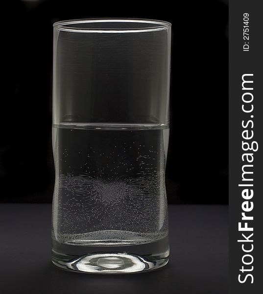 Tall glass holding water isolated on white background. Tall glass holding water isolated on white background