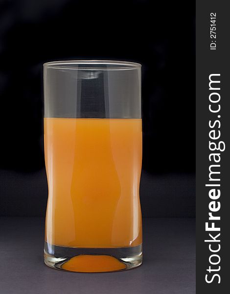 Tall glass holding orange juice isolated on white background. Tall glass holding orange juice isolated on white background