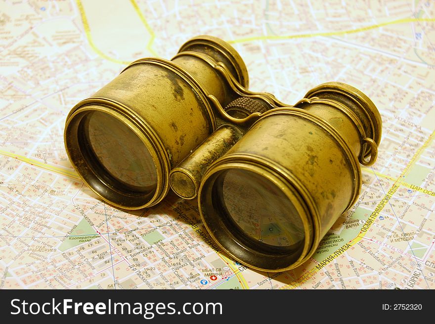 The antique binoculars on the map. The antique binoculars on the map