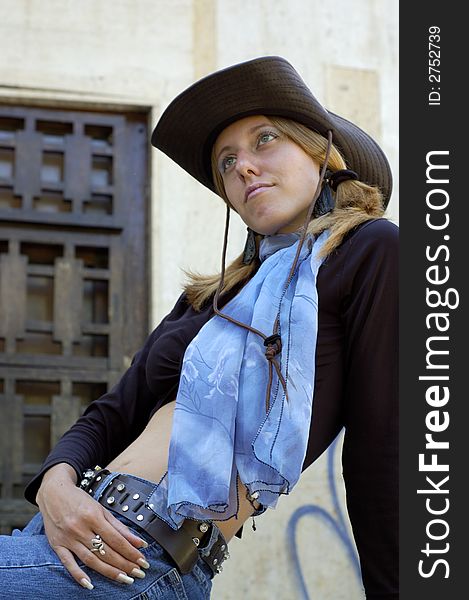 Classy blond woman hiding herself behind a black hat. Classy blond woman hiding herself behind a black hat.