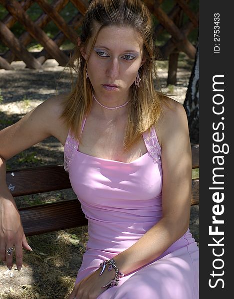 Woman in pink evening dress outdoors
