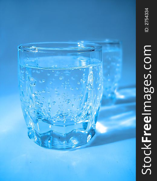 Glass with water in blue color