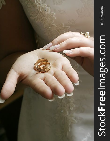 Wedding rings on a palm of the bride