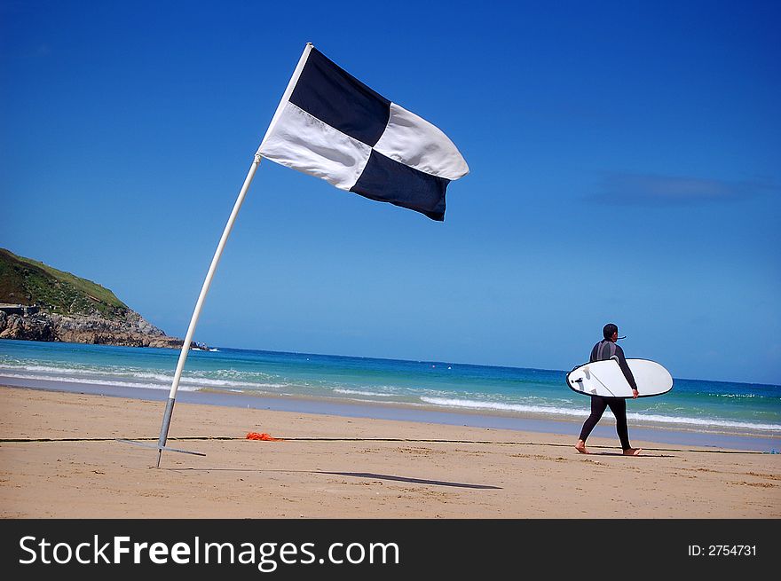A surfer and surf area flag. A surfer and surf area flag.