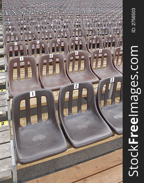 Brown seats in rows for sports/entertainment/concert background use. Brown seats in rows for sports/entertainment/concert background use