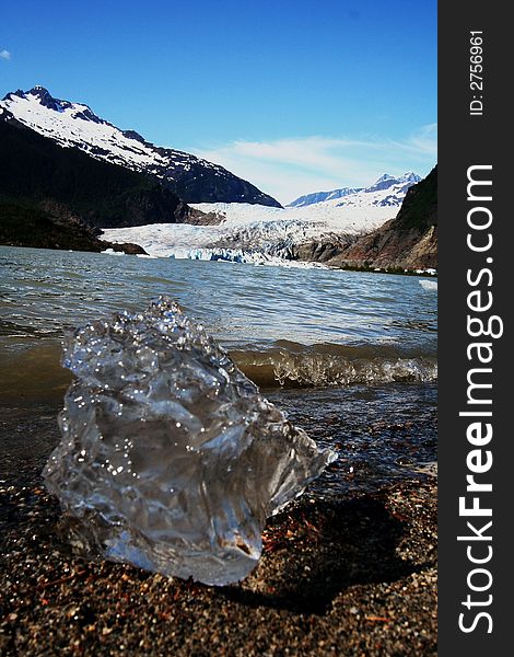 Chunk of ice washed up on shore in front of the Mendenhall Glacier in Juneau, Alaska. Chunk of ice washed up on shore in front of the Mendenhall Glacier in Juneau, Alaska.