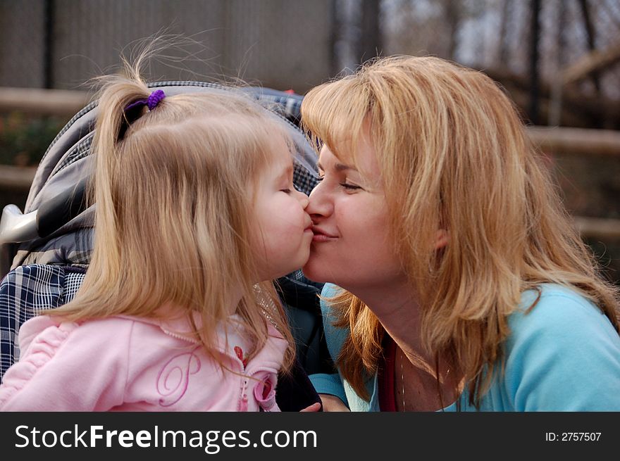 Two year old girl and her mother rubbing noses. Two year old girl and her mother rubbing noses.