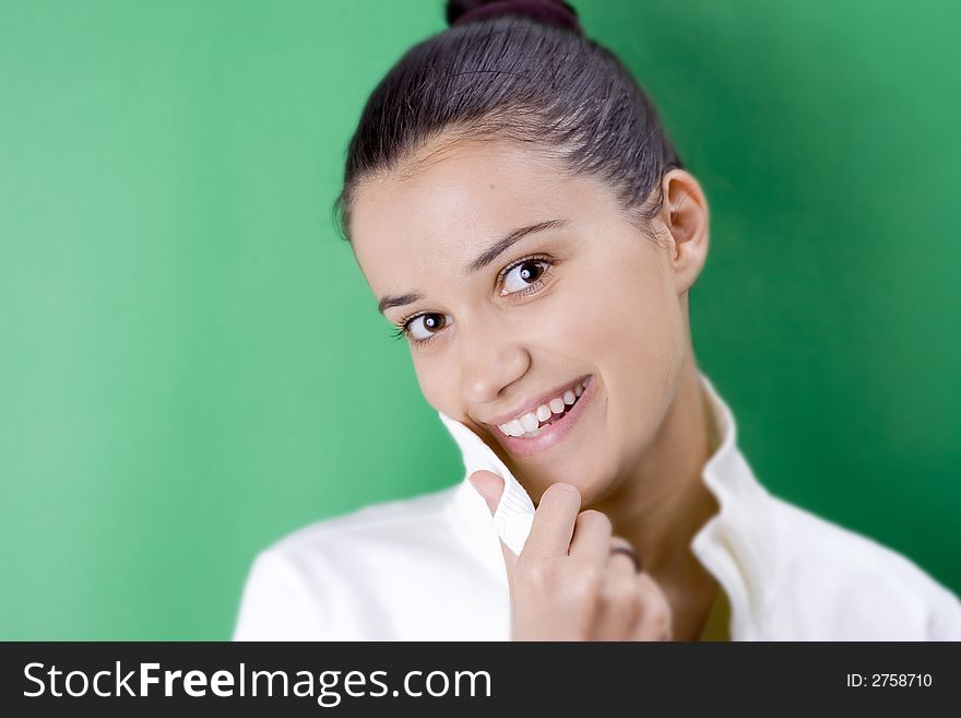 Smiling girl in white on green background