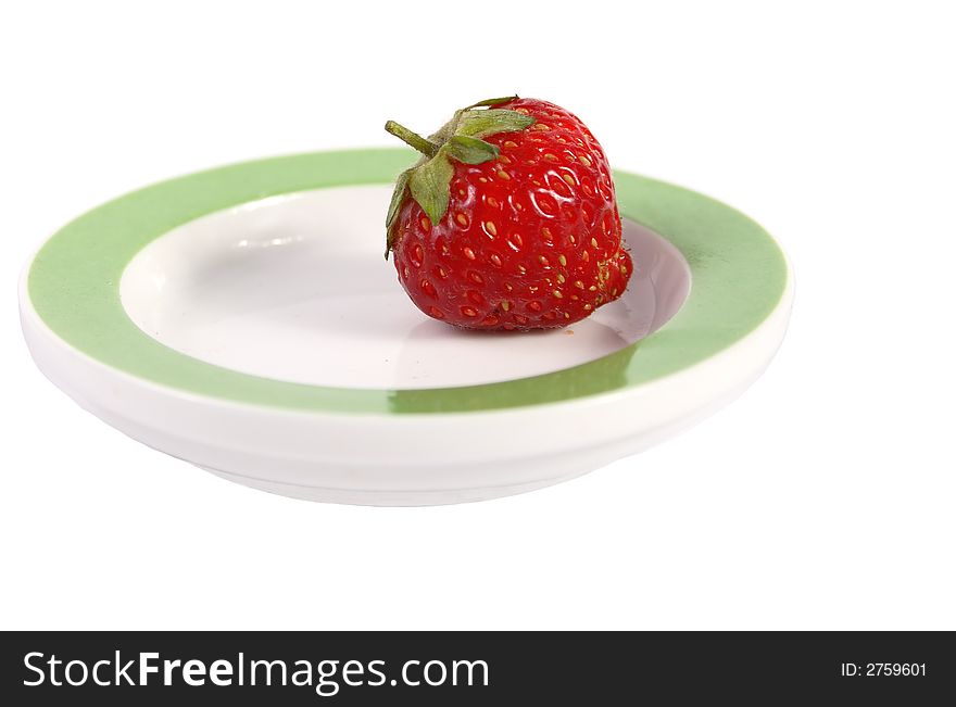 Red single strawberry on the round dish isolated