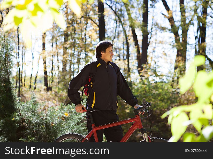 Tourist with a red bicycle