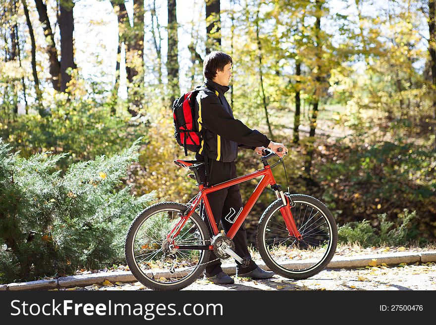 Man with the bike and sunny autumn day