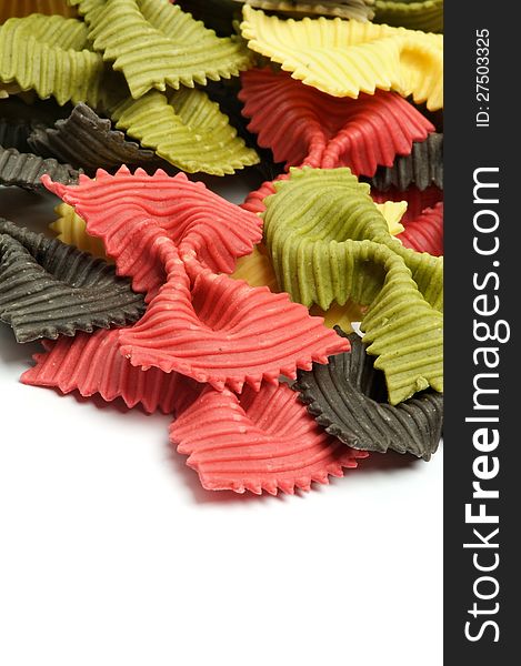 Raw Pasta Three Color Farfalle closeup on white background