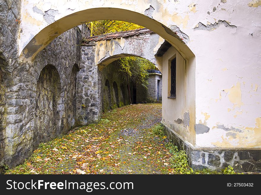 Medieval yard with arch and stone walls