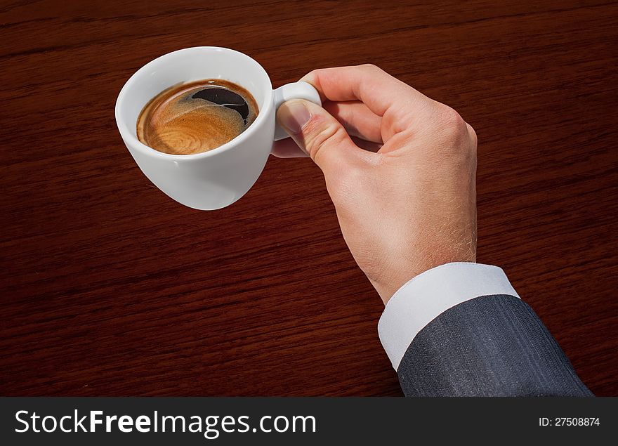 Businessman hand holding a cup of coffee. Businessman hand holding a cup of coffee