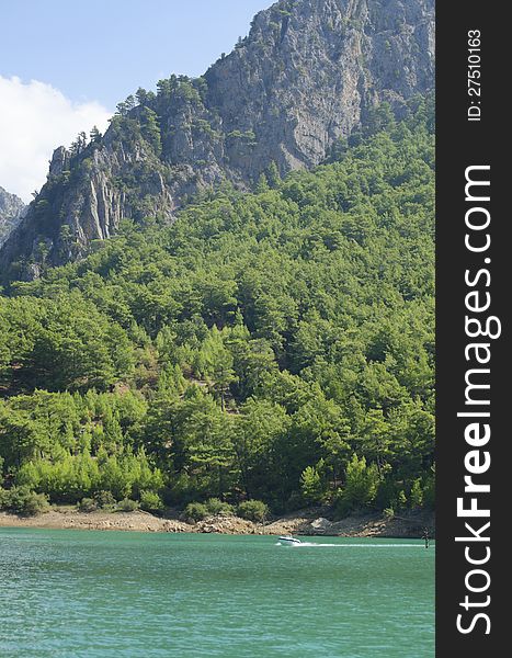 Rocky shore with trees against the blue sky. Rocky shore with trees against the blue sky