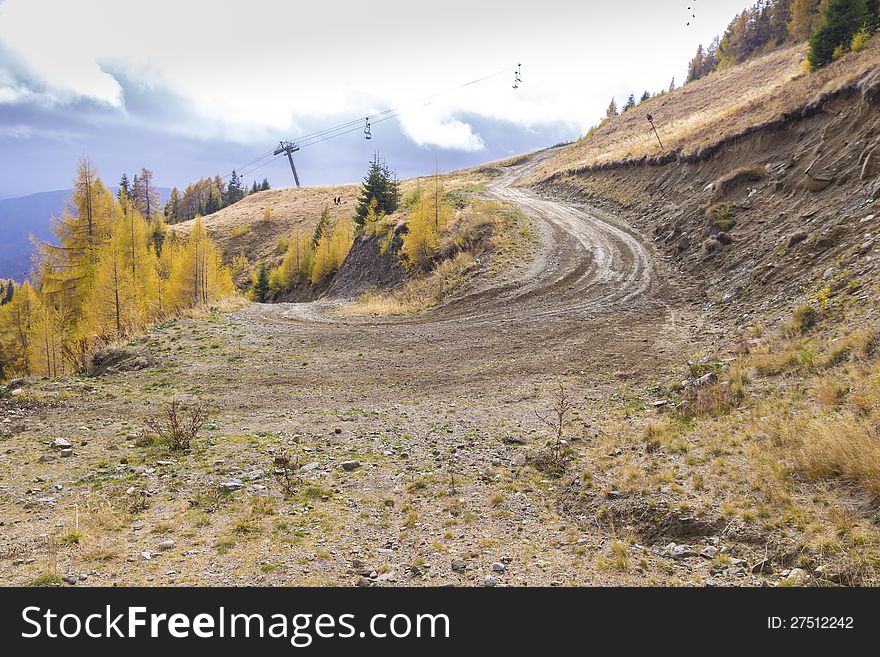 Forrest road in sinaia mountains with chair lift in background. Forrest road in sinaia mountains with chair lift in background