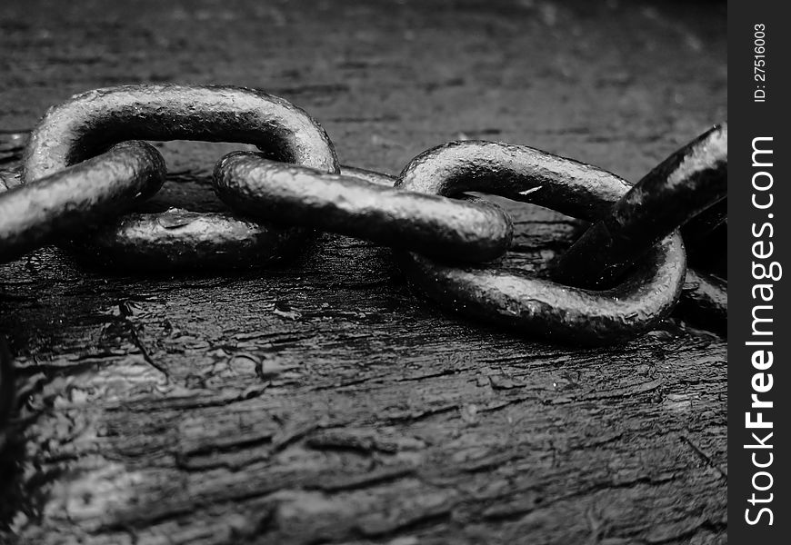 Black background with old wood surface and chain. Black background with old wood surface and chain