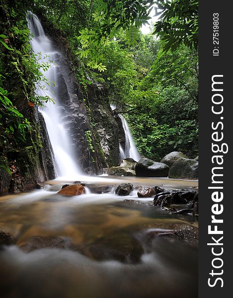 Waterfall with flow of the stream in tropical rainforest, Malaysia